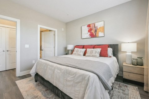 a bedroom with a bed and a door to a bathroom