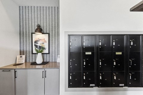 a kitchen with black lockers and a counter and a painting