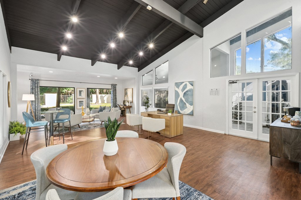 a living room with a dining room table and a kitchen