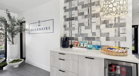 a kitchen with a counter and a sink and a wall with a sign on it