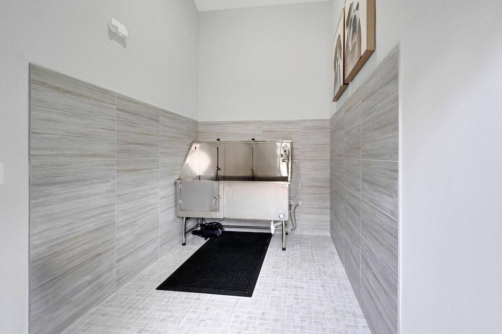 a spa room with a tub and a black rug on the floor
