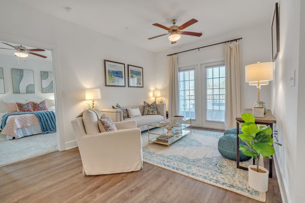 a living room with furniture and a ceiling fan