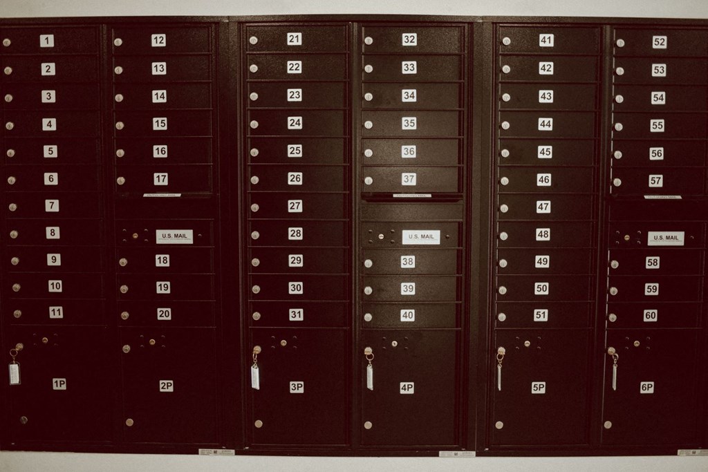 a row of mailboxes with numbers on the doors