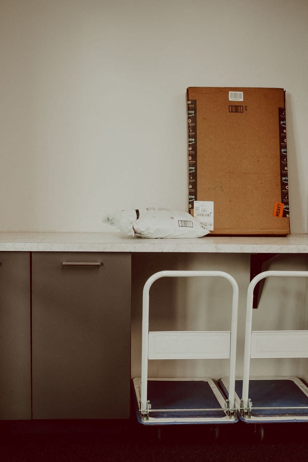 a desk with two chairs and a box on top of it
