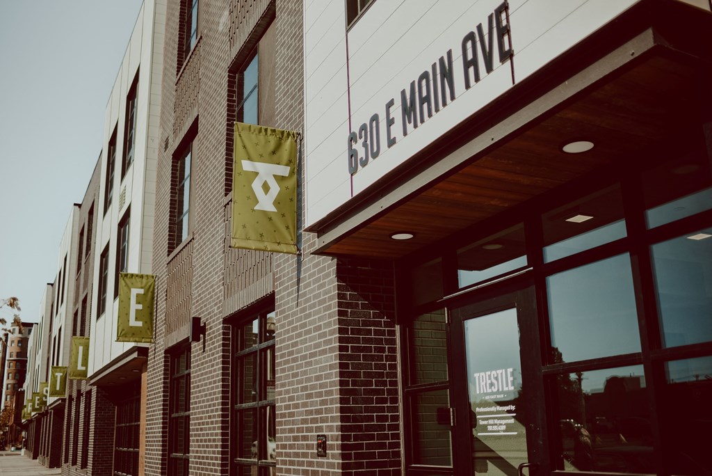 the front of a building with a sign on the side of it