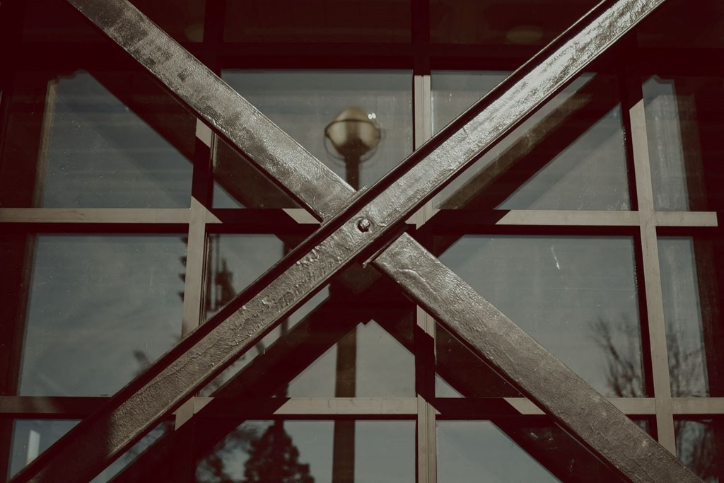 a close up of a glass door with a reflection of a lamp