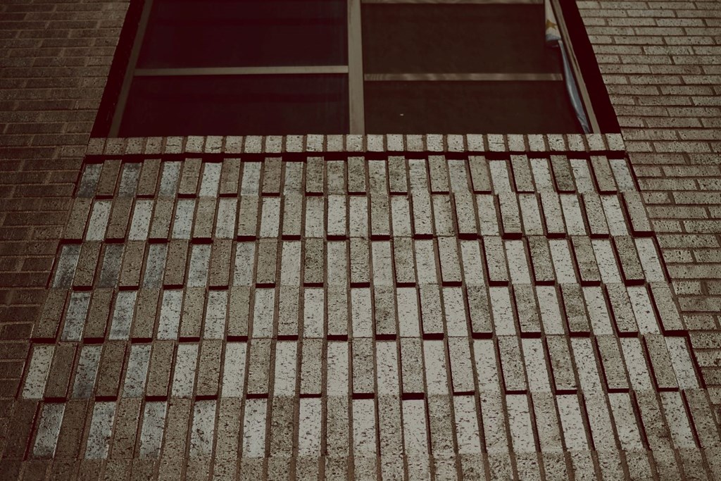 a brick staircase leading up to a window in a building