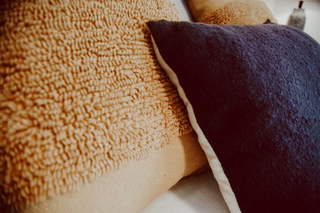 two pillows on top of each other on a table