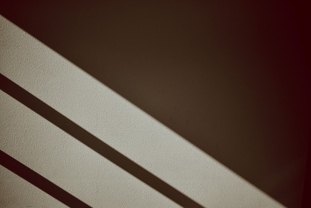 the sunlight shining through the blinds on a window