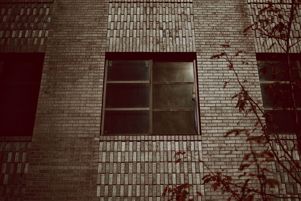 a window on the side of a brick building