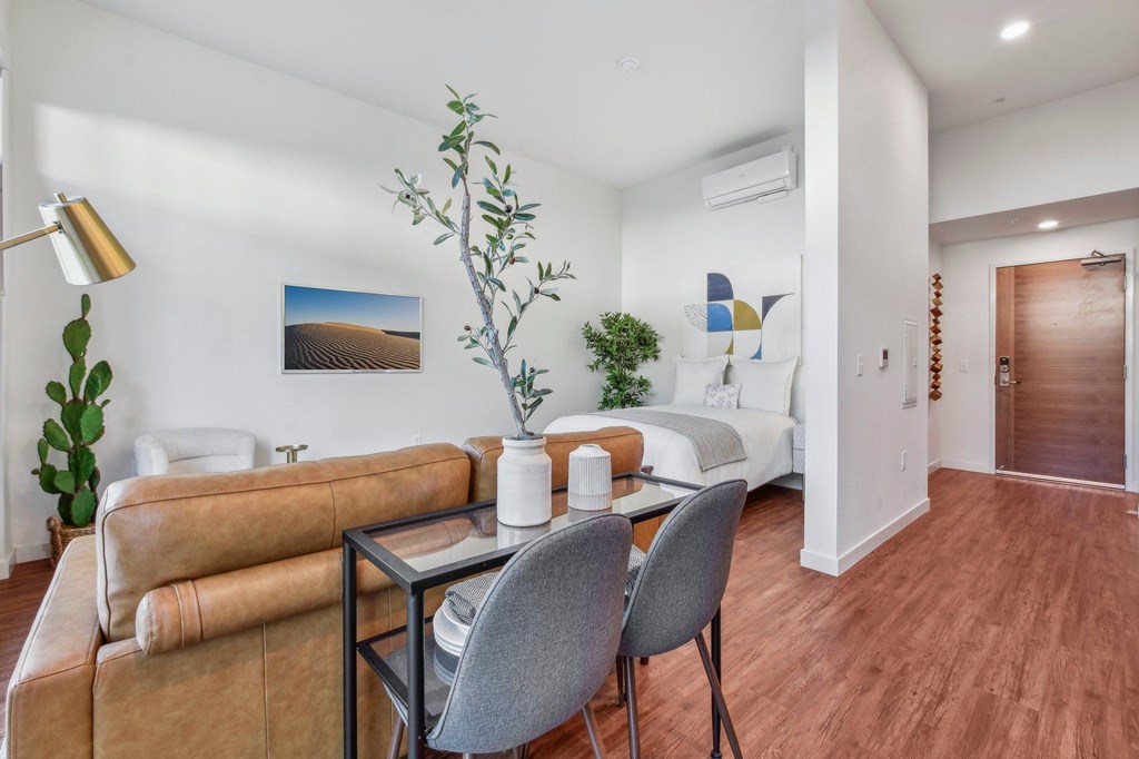 A living room with a brown sofa and a grey chair.