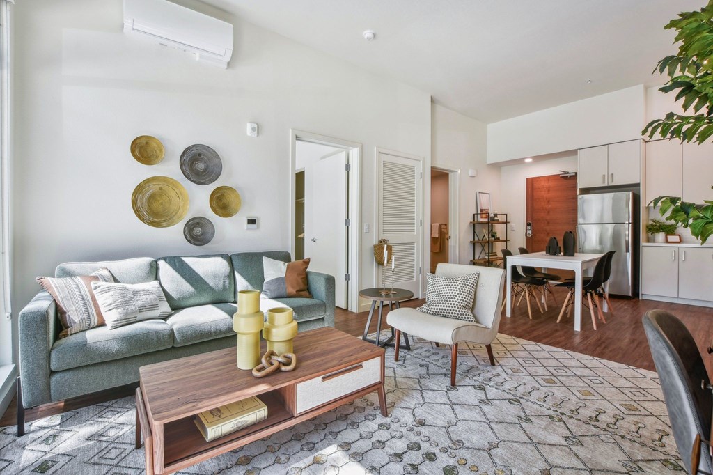 A living room with a grey couch and a coffee table.