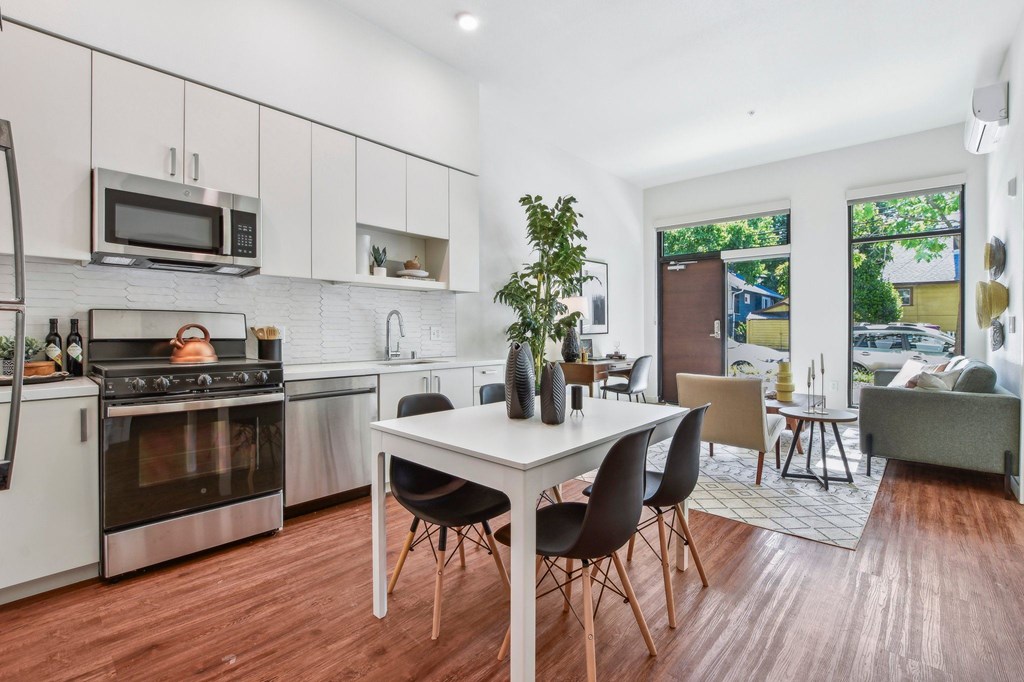 A modern kitchen with a dining table and chairs.