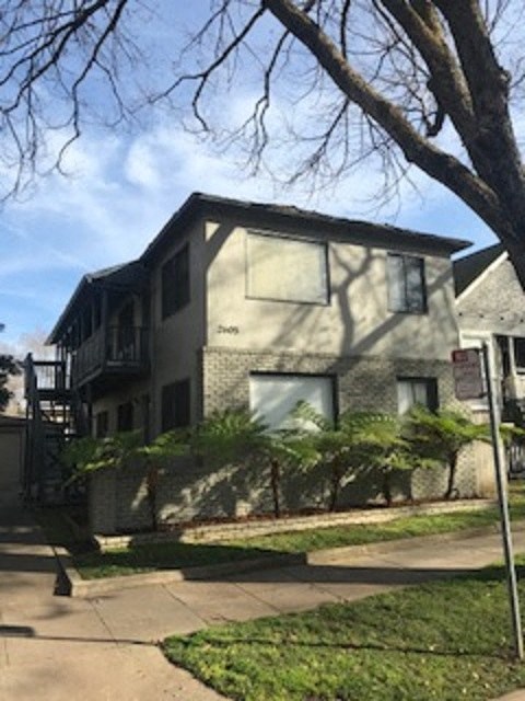 A house with a tree in front of it.