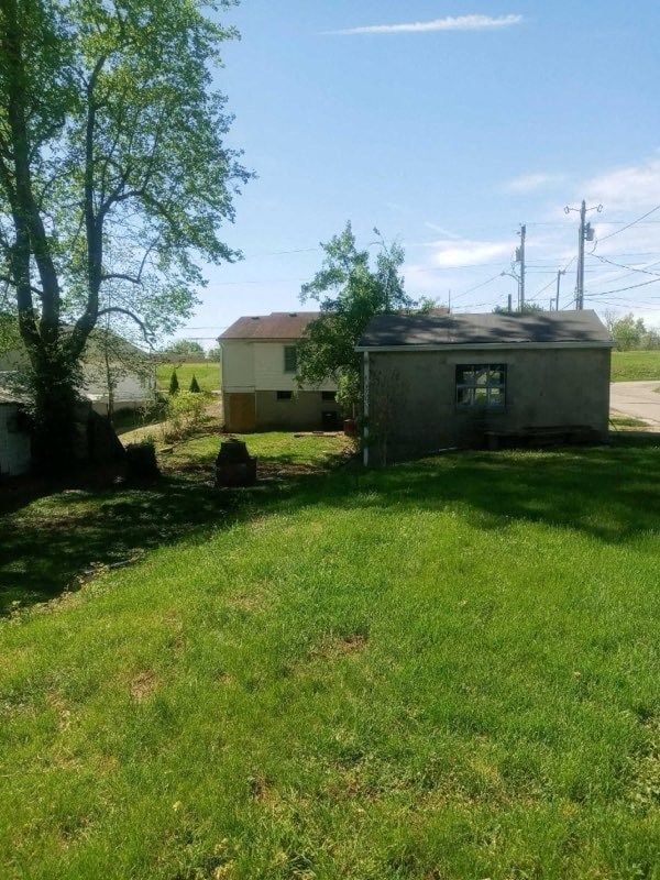 a small house on the side of a field