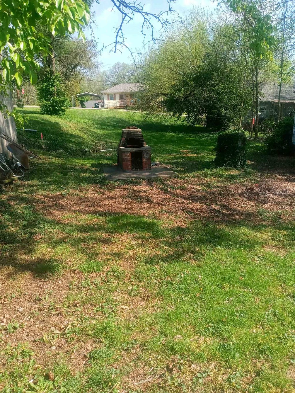 a fire pit in the middle of a grass field