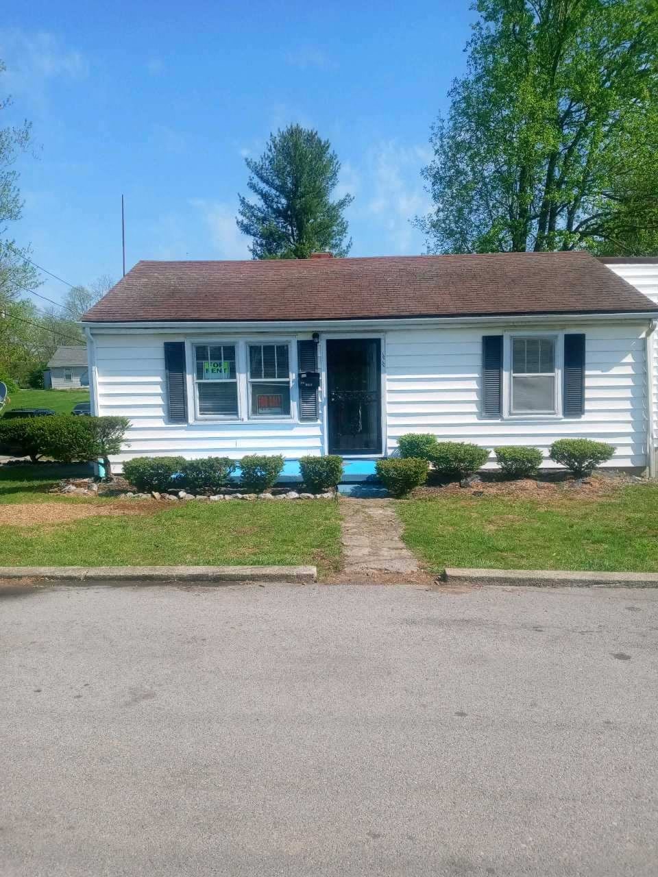 a white house with a sidewalk in front of it