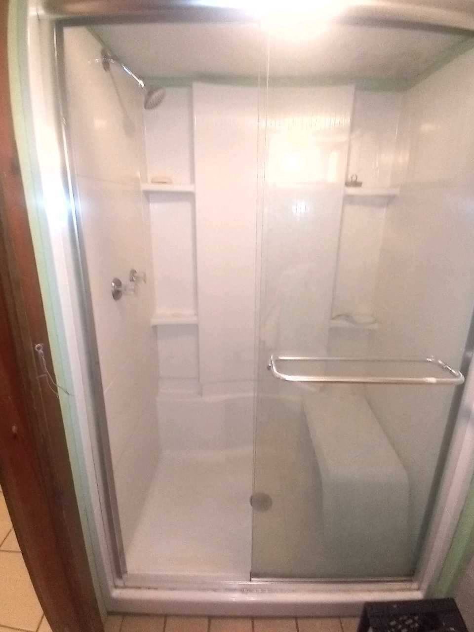 a bathroom with a shower and a toilet in it