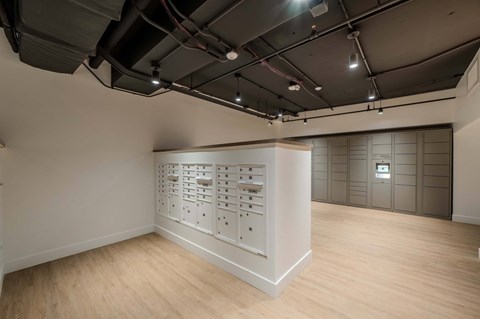 A room with a white wall and a wooden floor.