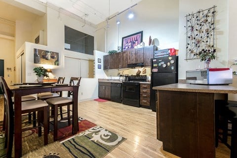 a kitchen and dining area with a table and a refrigerator
