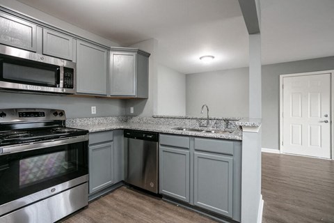 A kitchen with a stove top oven and microwave.