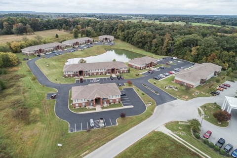 A large building complex with a parking lot in front.