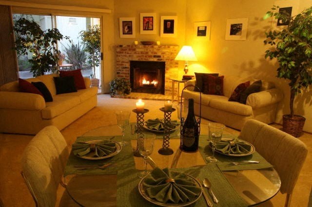 a living room with a table and chairs and a fireplace