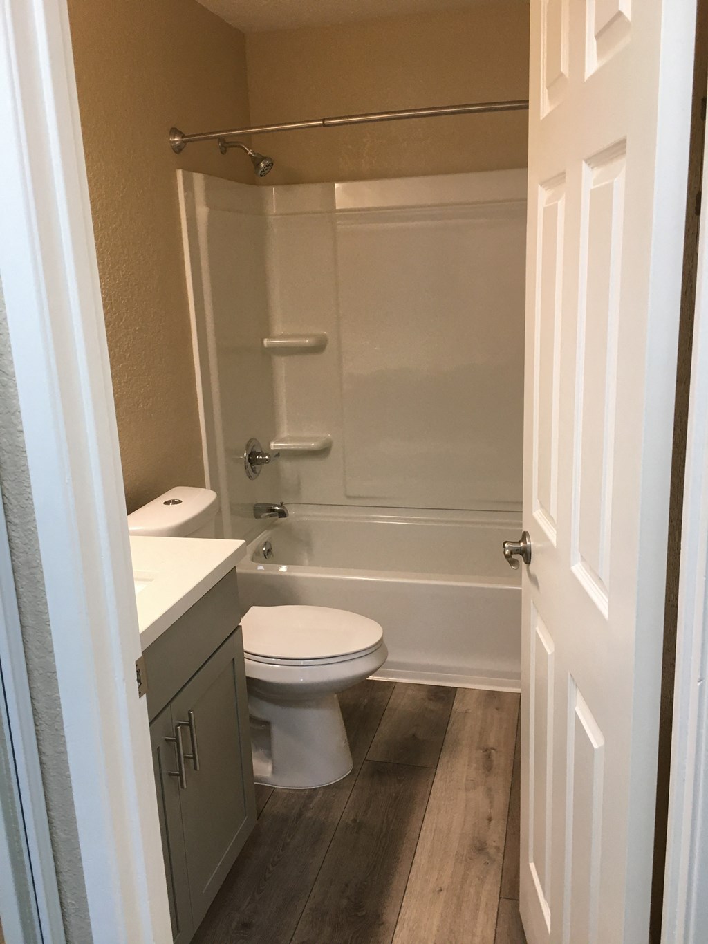 a small bathroom with a toilet and a bath tub