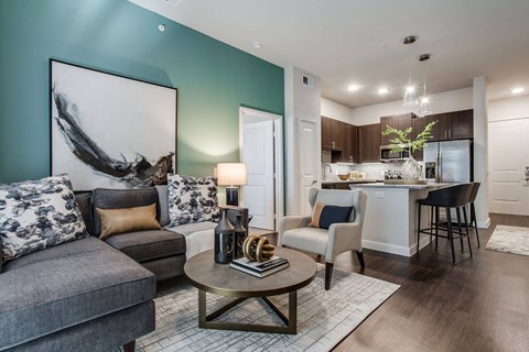 A modern living room with a grey sofa and a coffee table.