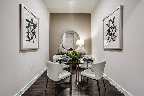 Open-concept dining room with modern furnishings, designer lighting, and convenient access to the gourmet kitchen.