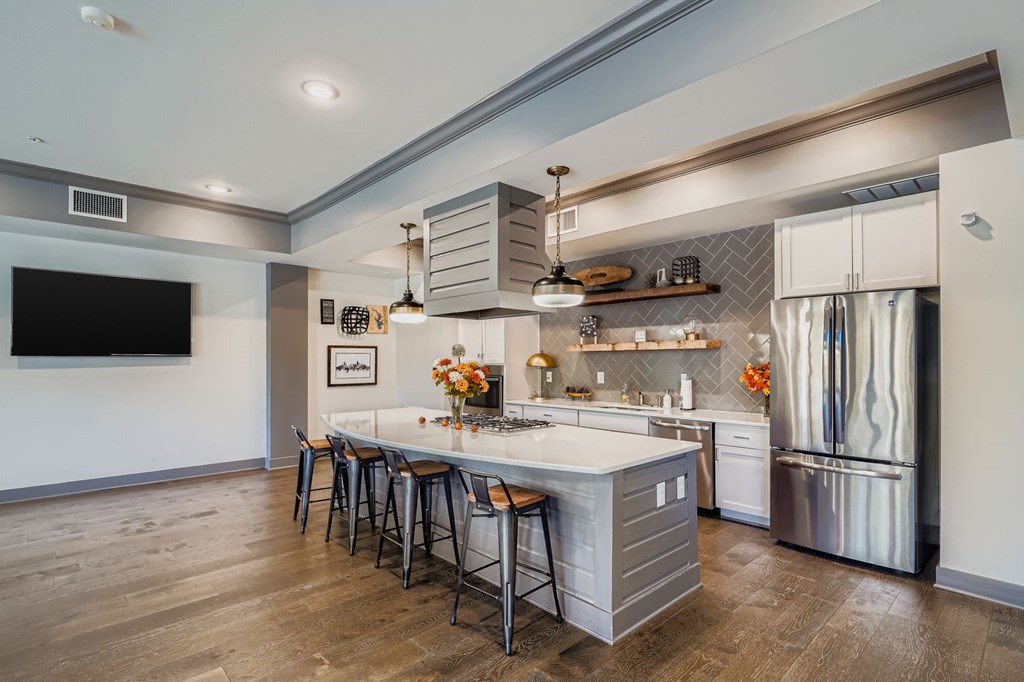 A modern kitchen with a large island and stainless steel appliances.