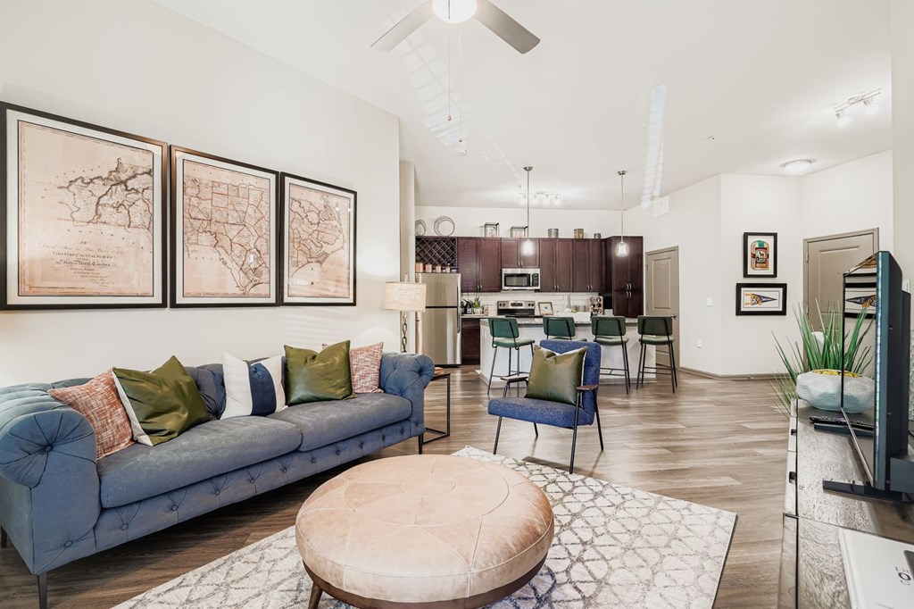 A living room with a blue couch and a coffee table.