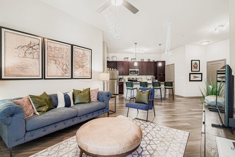 A living room with a blue couch and a coffee table.