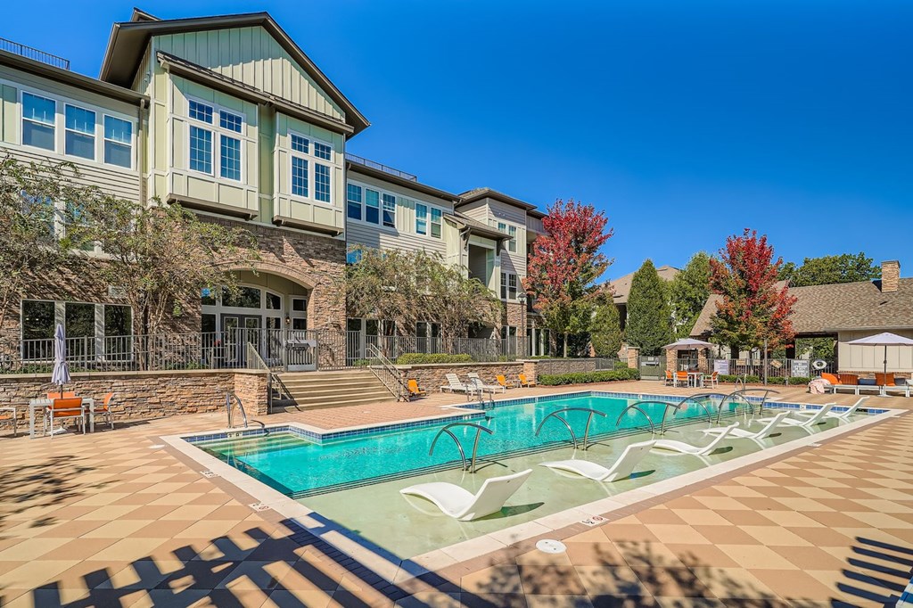 A large house with a pool in front.