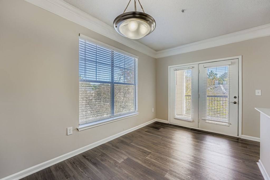 A room with a sliding glass door and a wooden floor.