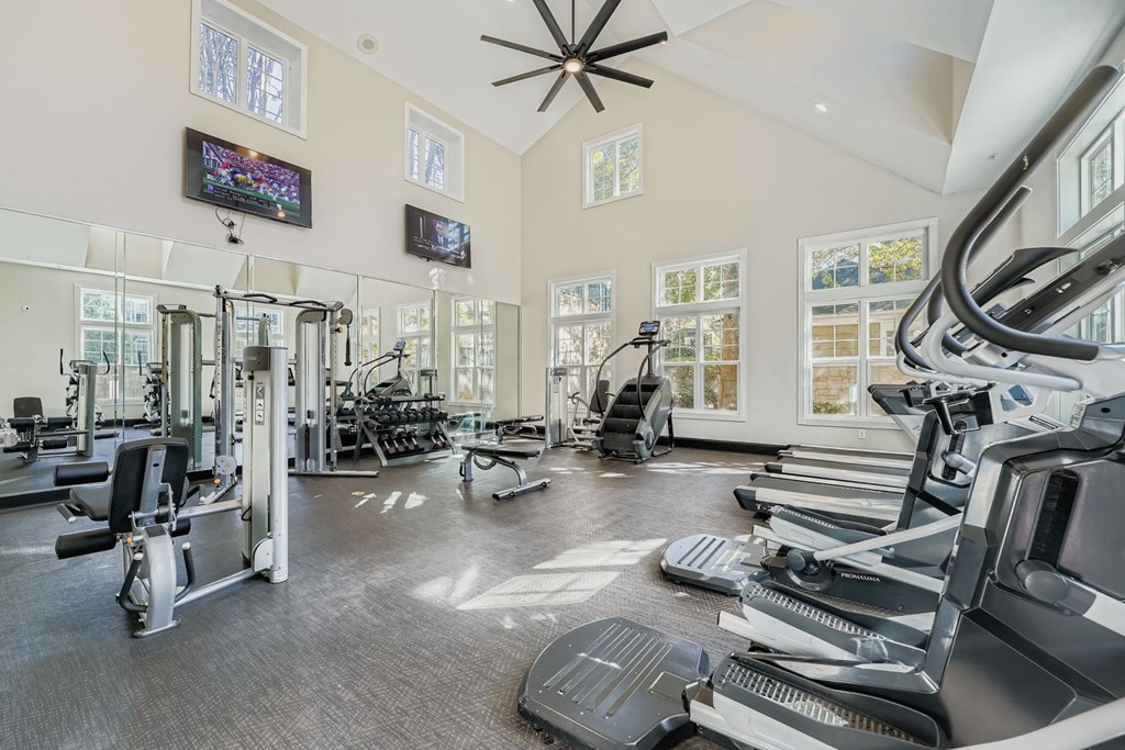A spacious gym with treadmills, elliptical machines, and other exercise equipment.