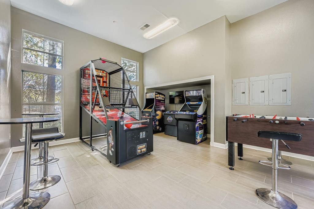 A room with a pool table and a dartboard.