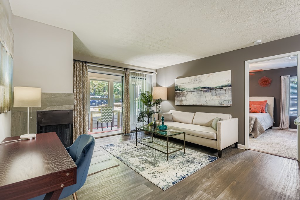 A living room with a couch, a coffee table, and a fireplace.