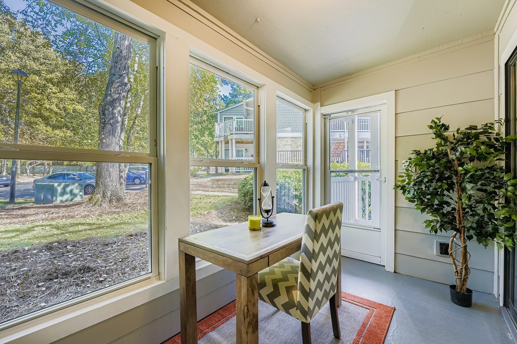 A dining room with a table and chairs.