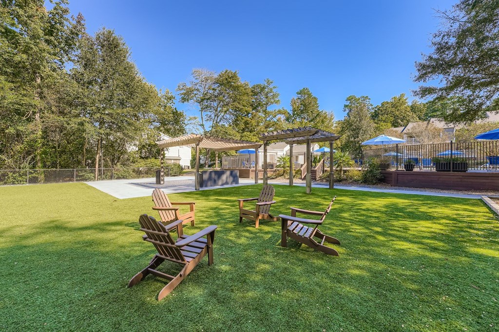 A backyard with a wooden bench and a gazebo.