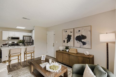 A living room with a brown coffee table and a green couch.