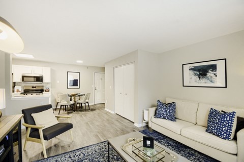 A living room with a white couch and a coffee table.