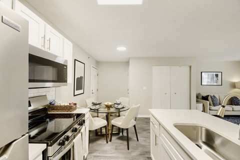 A modern kitchen with a dining table and chairs.
