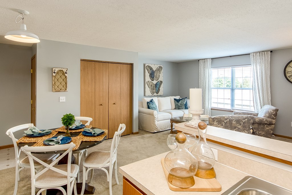 A kitchen with a dining table set for four.