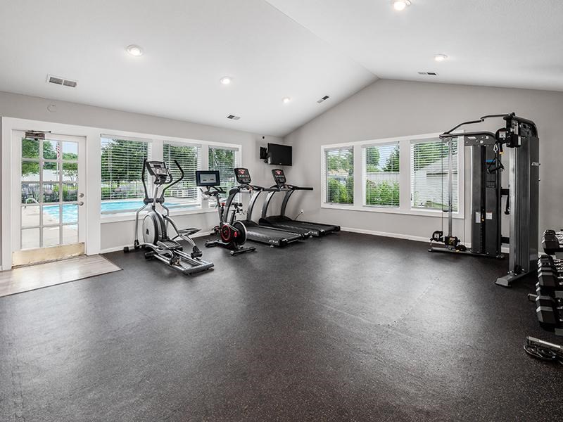 A spacious home gym with a variety of exercise equipment.