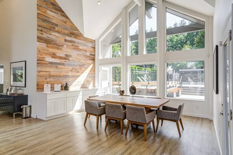 A dining room with a wooden table and chairs.