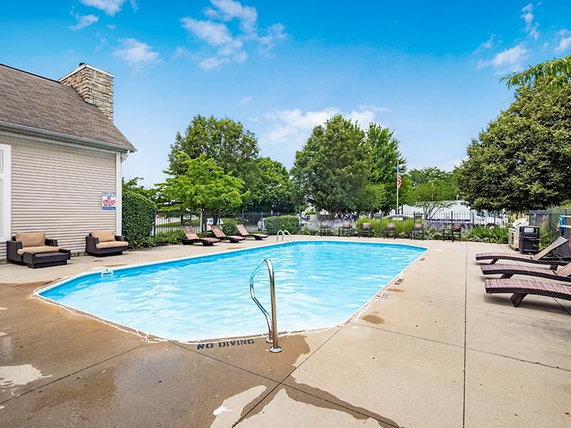 A pool with a diving board and a sign that says