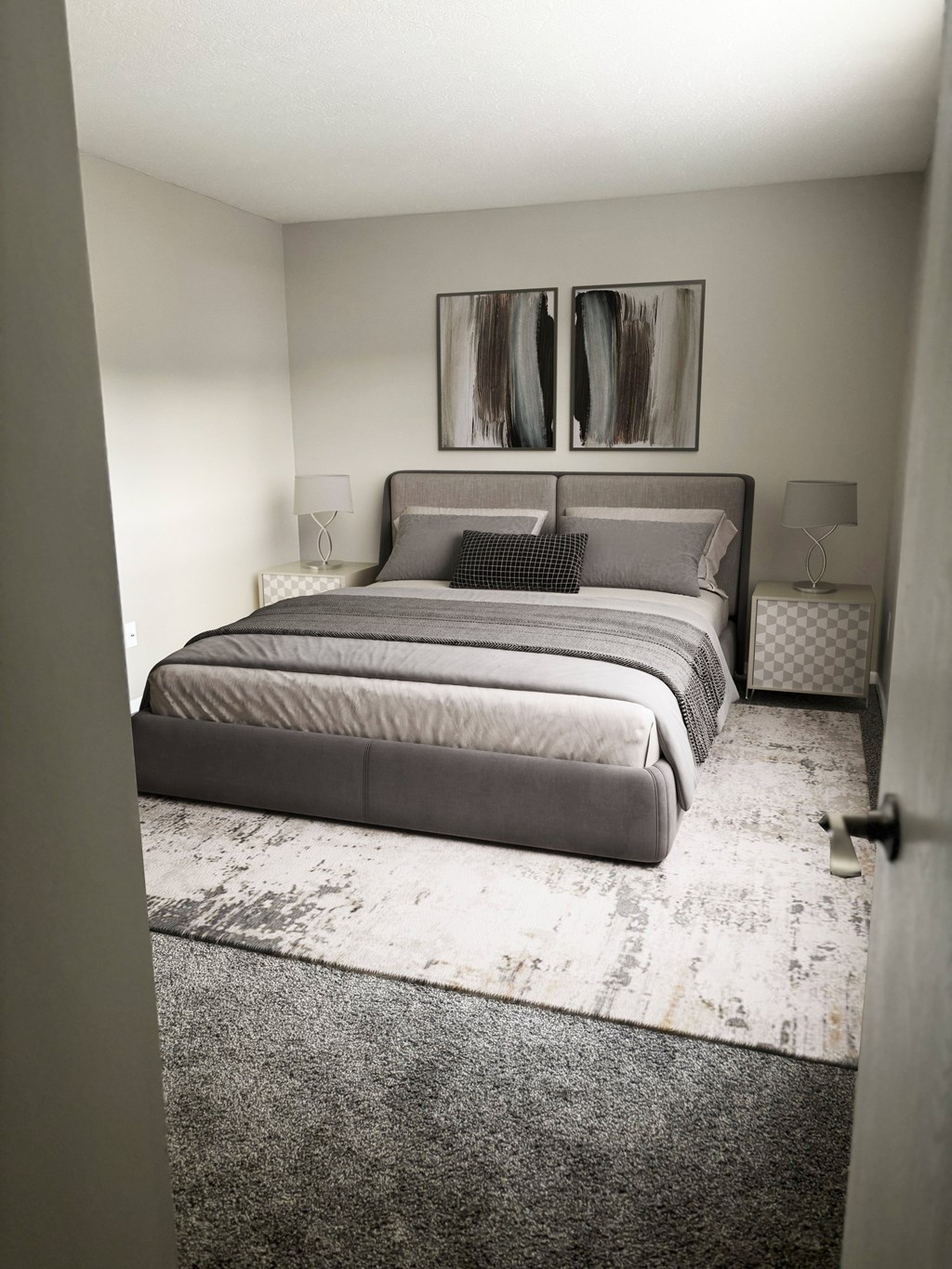 A bedroom with a large bed and a painting on the wall.