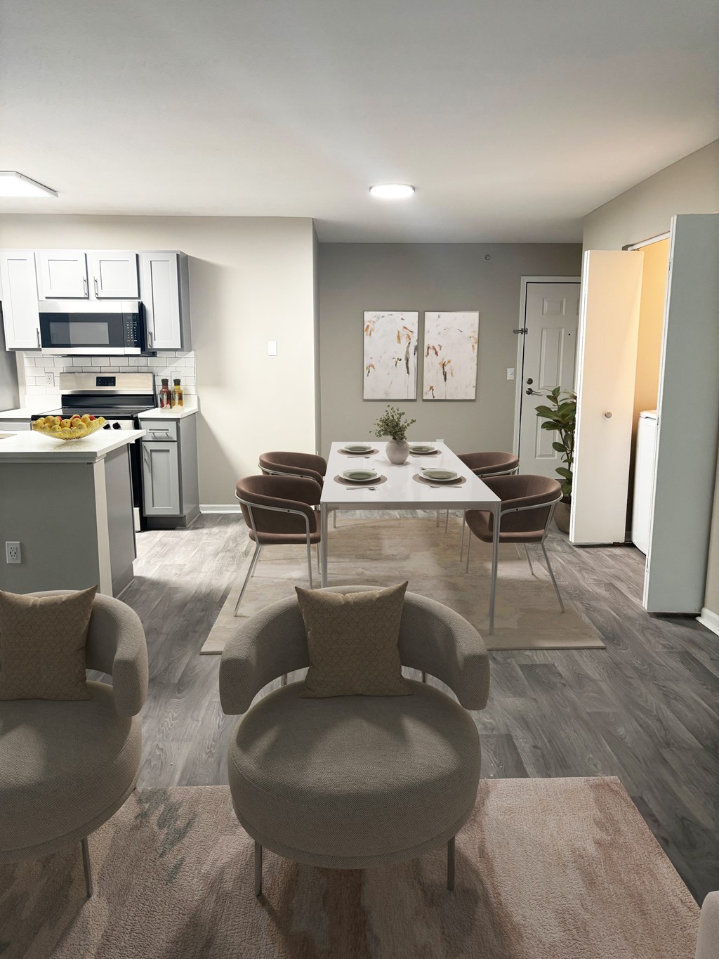 A modern kitchen with a dining table and chairs.