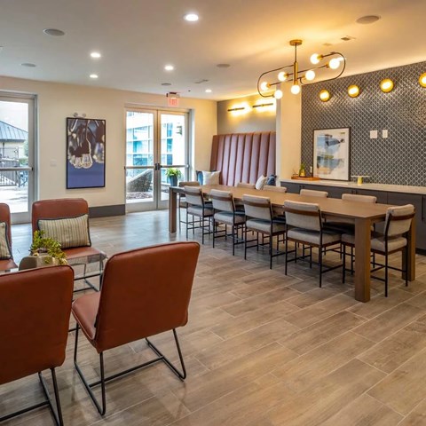 A dining room with a long table and chairs.